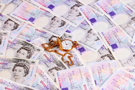 Antique pocket watch on the background of paper money bills