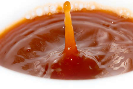 A drop of water creates fantastic patterns when falling on the surface of a liquidの写真素材