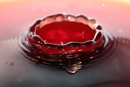Fantasy textures and patterns on the surface of the drink created by a water drop when falling from a heightの写真素材