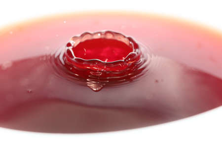 Fantasy textures and patterns on the surface of the drink created by a water drop when falling from a heightの写真素材