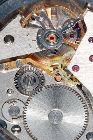 Gears and a pendulum with a spring to support a constant movement in the clock mechanism