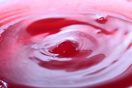 Drop of water when falling patterns on the surface of a liquidの写真素材