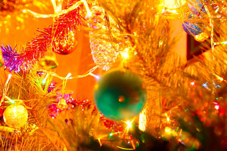 Festively decorated New Year tree with lighting and glass toysの写真素材