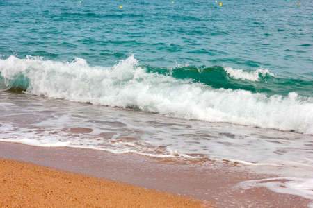 Clean clear sea waves and beautiful sandy beachの写真素材