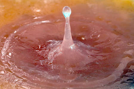 Fine splashes and drops of liquid when falling on the surface of water