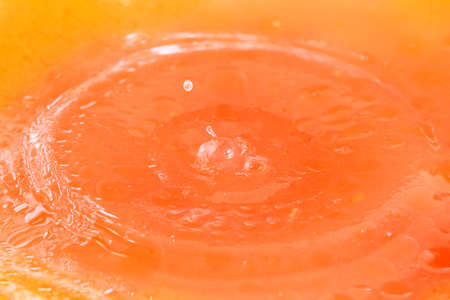 Fine splashes and drops of liquid when falling on the surface of waterの写真素材