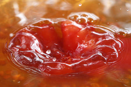 Drops of water and waves upon the surface of a liquid in a containerの写真素材