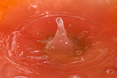 Drops of juice and amazing patterns on the surface of the liquidの写真素材