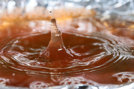 Drops of juice and amazing patterns on the surface of the liquidの写真素材