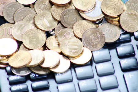 Metallic Russian coins gold ruble and calculator for calculating dividendsの写真素材
