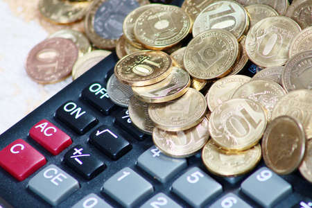 Metallic Russian coins gold ruble and calculator for calculating dividendsの写真素材