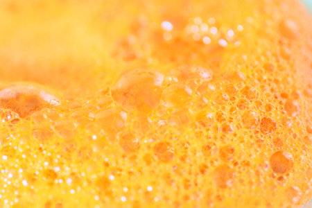 a variety of patterns and air bubbles on the surface of carrot juiceの写真素材