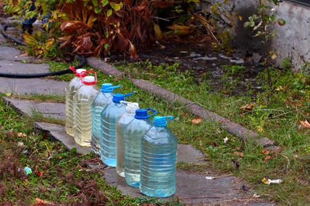plastic jerricans with clean water in the garden section of the country houseの写真素材