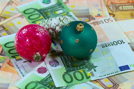 a bunch of European paper euro bills and glass Christmas toysの写真素材