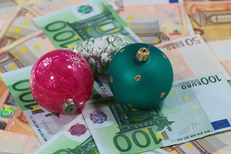 a pile of paper euros and Christmas toysの写真素材
