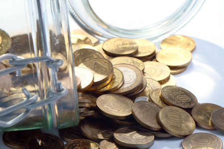 a heap of metallic Russian ruble in a glass jarの写真素材