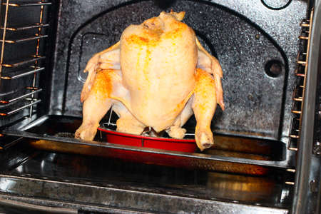 process of cooking a carcass of a young chicken in the ovenの写真素材