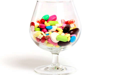 a variety of medicines and tablets in glassの写真素材