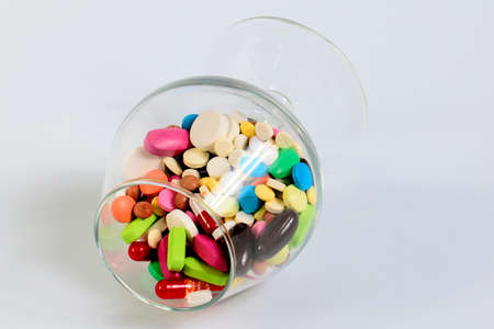 a variety of medicines and tablets in glass