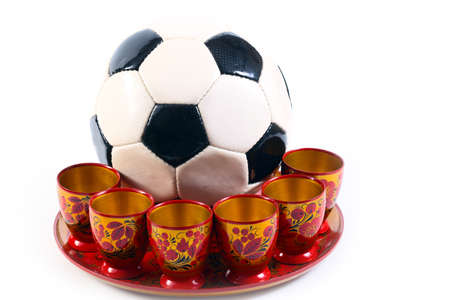 A soccer ball in a wooden bowl painted in Russian traditionsの写真素材
