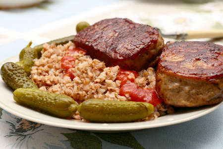 meat cutlets and garnish with buckwheat with pickled cucumbersの写真素材