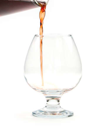 Beautiful patterns pouring into a glass of red wineの写真素材