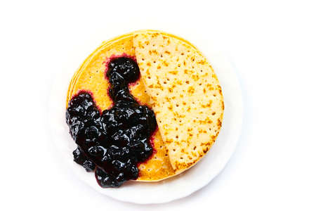 a stack of beautiful pancakes and a bunch of fresh jamの写真素材