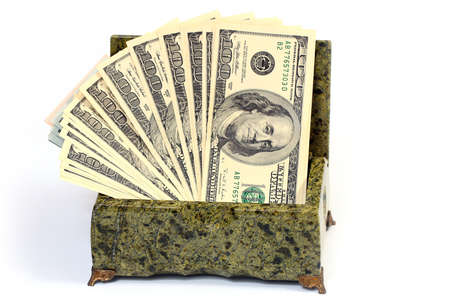 pile of paper American dollar bills in malachite casket