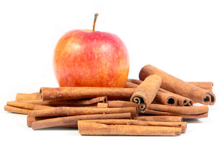 fresh cinnamon sticks and a beautiful ripe appleの写真素材