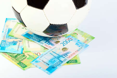 Football ball and paper Russian rubles as the national currency of the championshipの写真素材