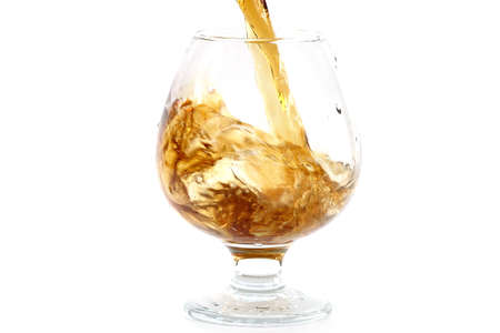 strong alcohol is poured into a glass for consumption