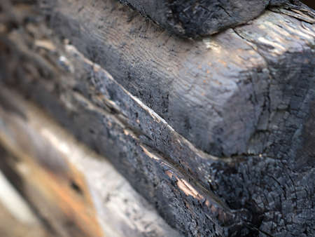 charred wooden beams and logs in place of a rural fireの写真素材