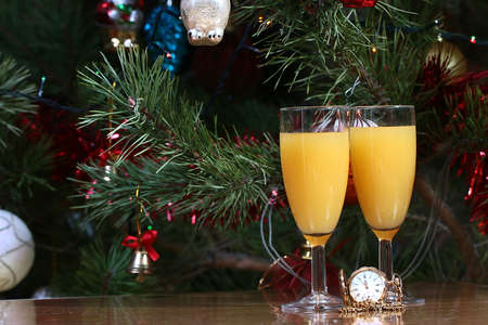 Christmas pine and two glasses of wine as a symbol of the holidayの写真素材