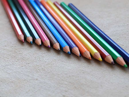 a set of colored pencils for drawing lies on a piece of real leather