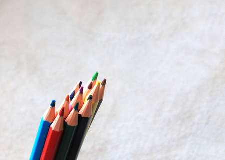 a set of colored pencils for drawing lies on a piece of real leatherの写真素材