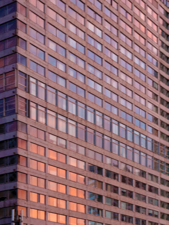 Close up of modern office building with glass windows. Business background.