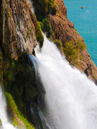 the rapid flow of clear water from Duden Waterfall in Antalya on the Turkish coast