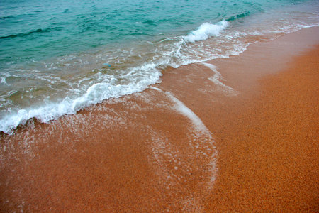 clean sea water washes the beautiful sandy shoreの写真素材