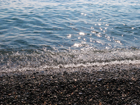 beautiful pebble beach and sea wavesの写真素材