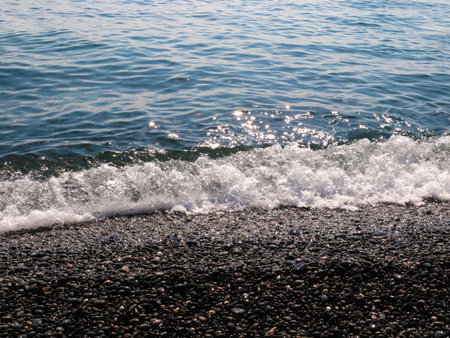 beautiful pebble beach and sea wavesの写真素材