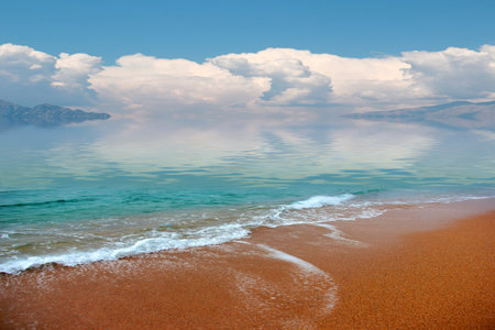 beautiful sandy beach and cloudy sunny sky as a place of entertainmentの写真素材