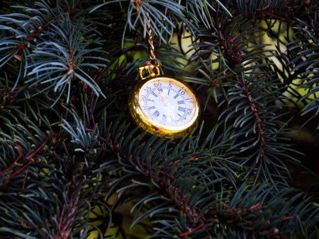 antique pocket watch on a branch of a festive Christmas tree