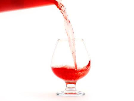 the flow of red wine when pouring it into a glass