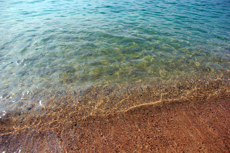 beautiful sea waves and a sandy beach as a vacation spotの写真素材
