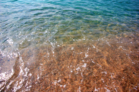 beautiful sea waves and a sandy beach as a vacation spotの写真素材