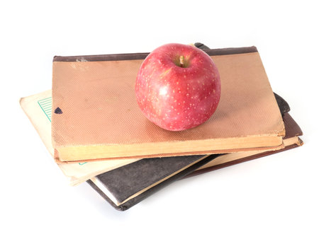 beautiful ripe apple and old books as a passion for learningの写真素材