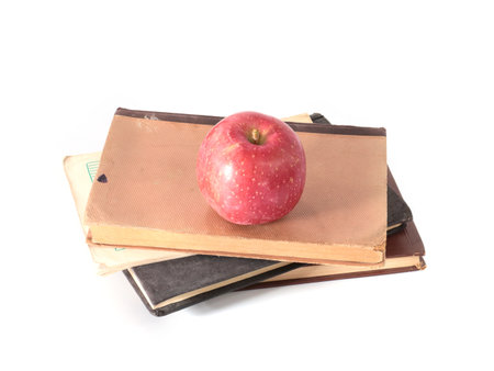 beautiful ripe apple and old books as a passion for learningの写真素材