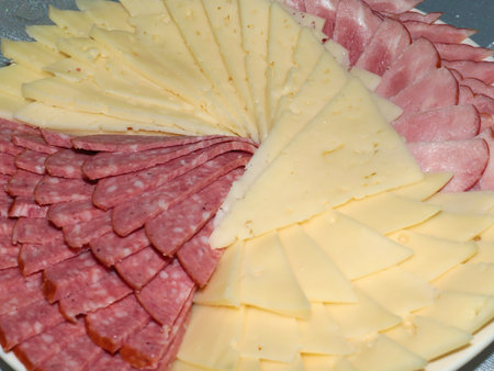 delicious pieces of smoked sausage and milk cheese as an element of a festive dinnerの写真素材