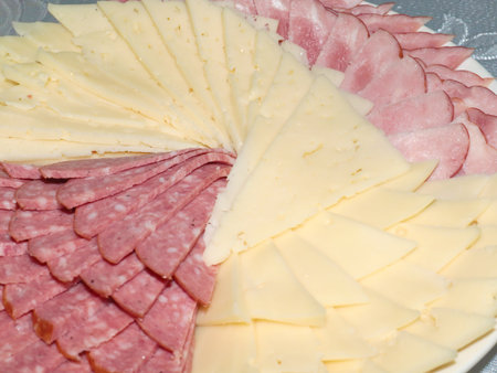 delicious pieces of smoked sausage and milk cheese as an element of a festive dinnerの写真素材