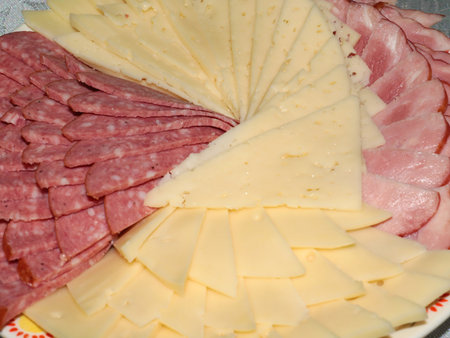 delicious pieces of smoked sausage and milk cheese as an element of a festive dinnerの写真素材